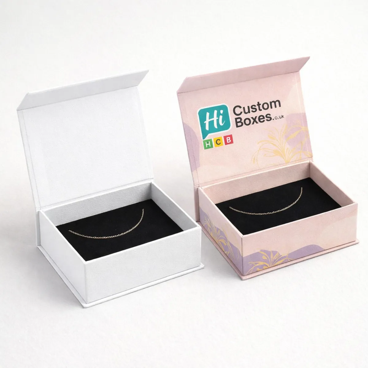 Branded magnetic flip-top anklet boxes in minimalist white and decorative pink with black velvet lining- class=